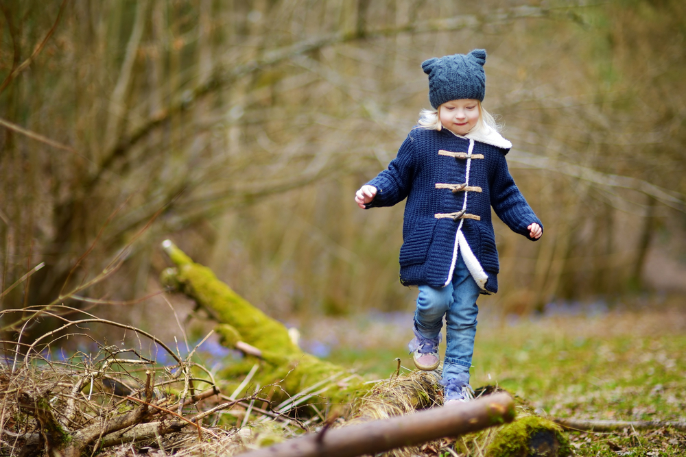 girl walking through the woods